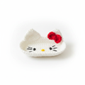 Handcrafted white Hello Kitty inspired crochet eyeglasses holder with red bow on white background